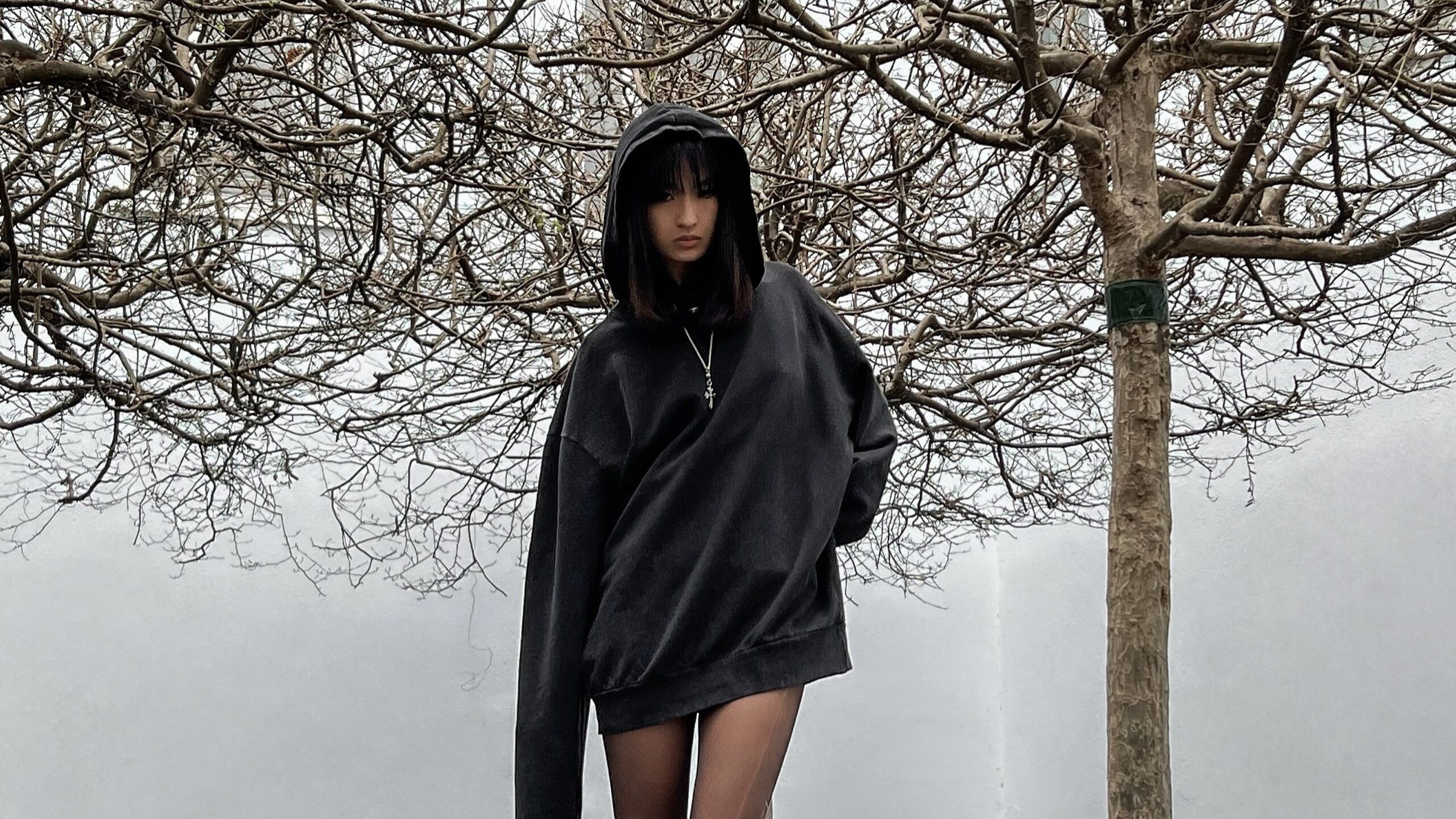 jiayuxuu in Black-on-Black Acid Hoodie by BAD PORTIER
