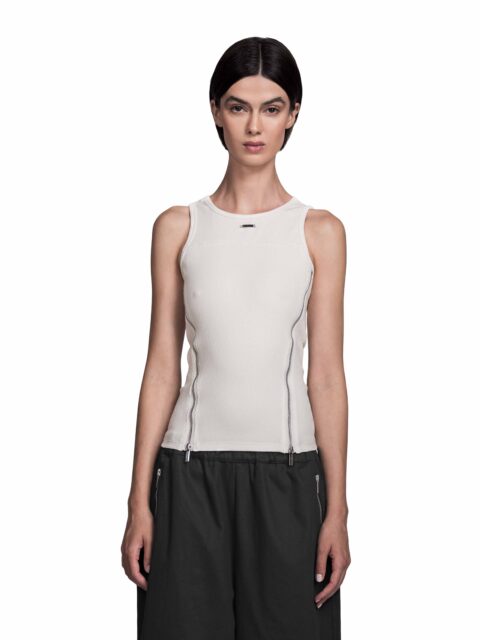 Cropped Front view of Model Vitoria Mota wearing the Sternum Tanktop Black from BAD PORTIER's OPERATION AW25 capsule. Slim cotton tank with two diagonal chrome zippers and panel seams for a sharp V-shape.